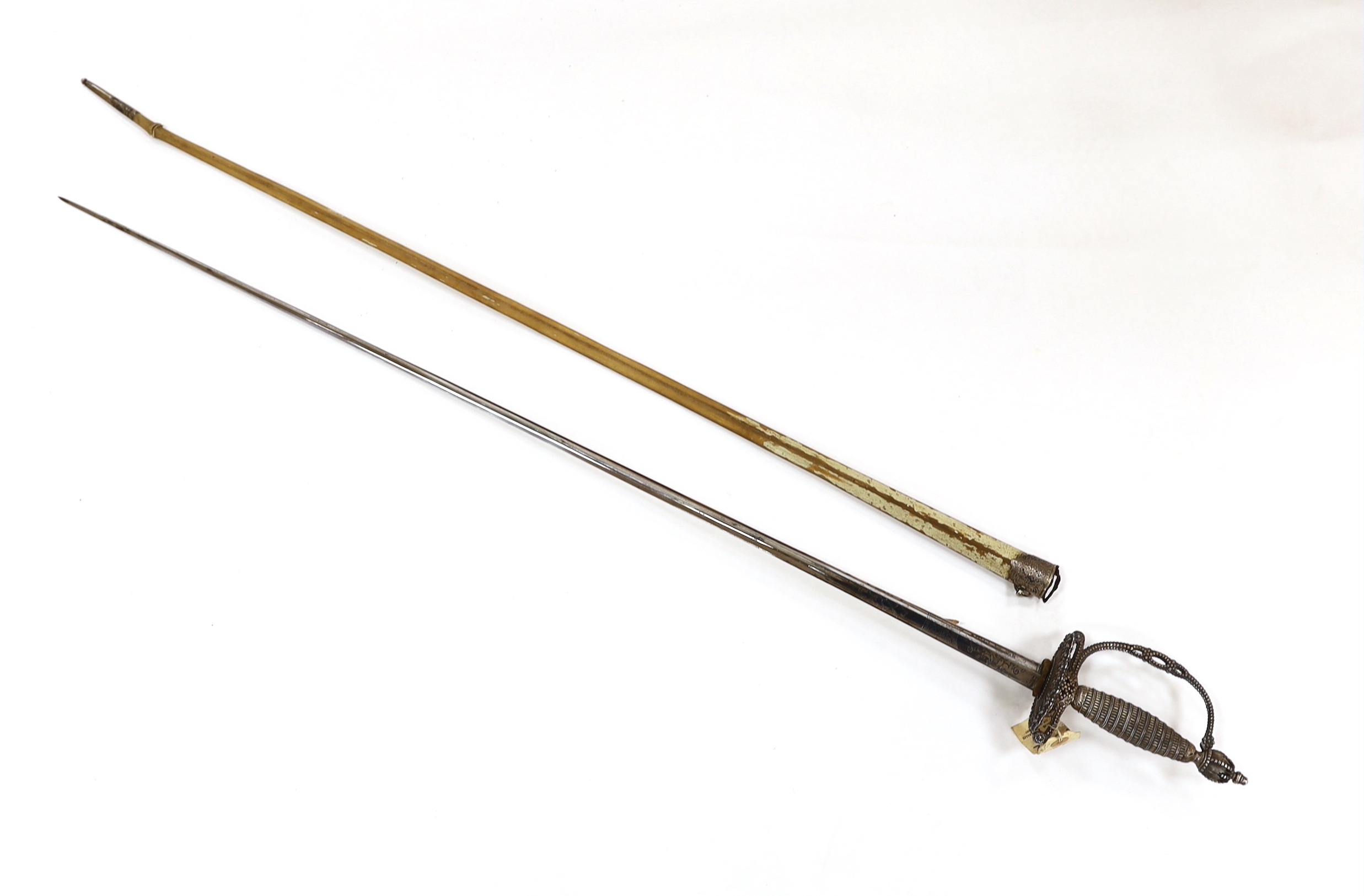 An English small sword, c.1775, pierced with facetted stud work, silver tape and wire bound grip, triangular section etched blade, in its original vellum scabbard and silver mounts, top mount engraved Dieltry Royal Excha